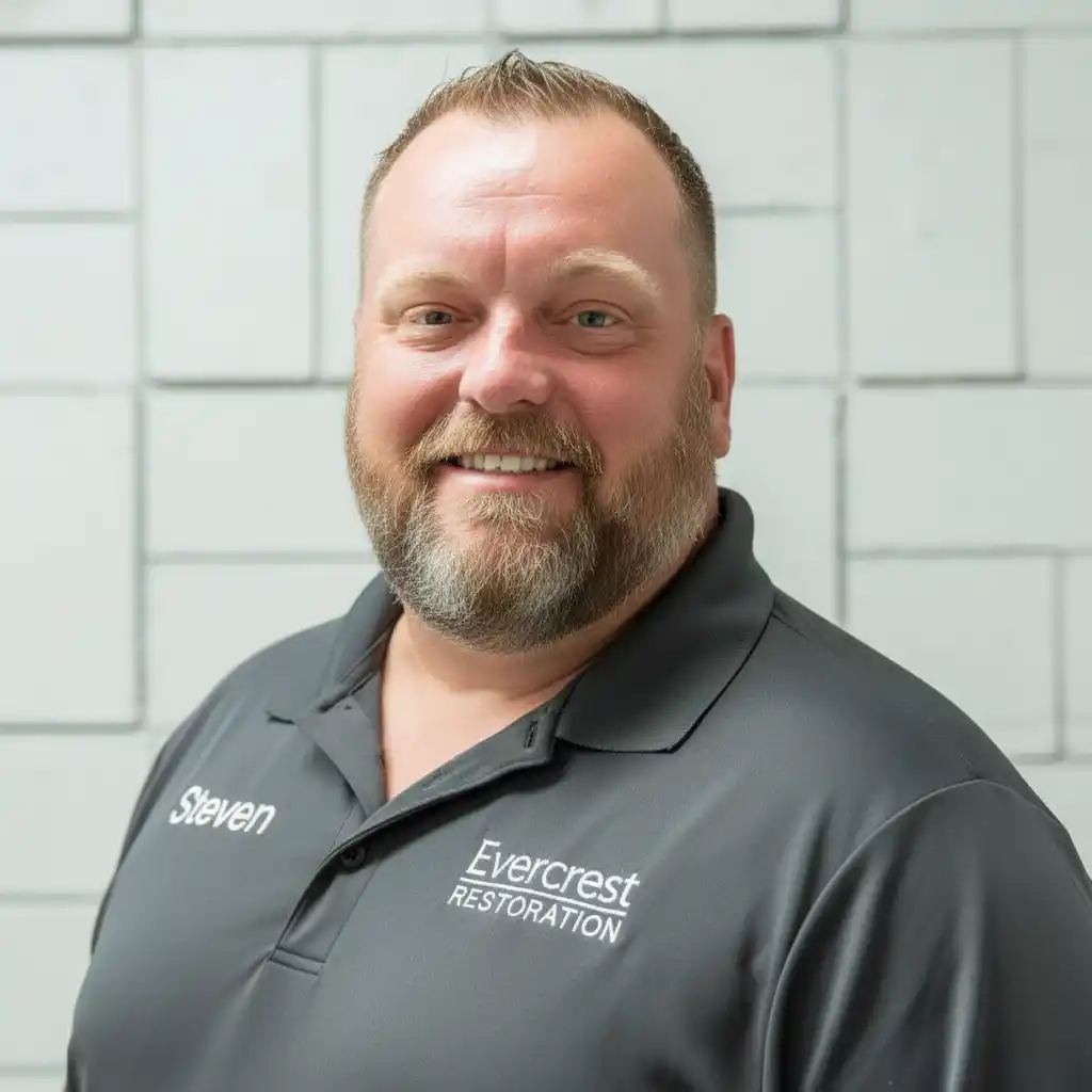 Steven Moore, owner of Evercrest Restoration, standing confidently in professional attire